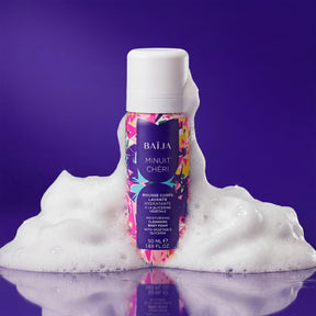 Mousse corps lavante hydratante Baïja Minuit Chéri à la glycérine végétale, entourée d’une mousse onctueuse sur fond violet, évoquant un rituel de douche sensoriel.